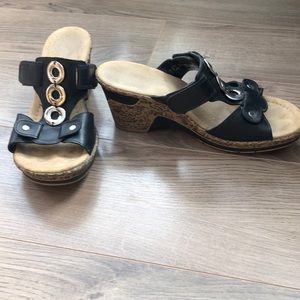Black wedge sandals with metal accents
